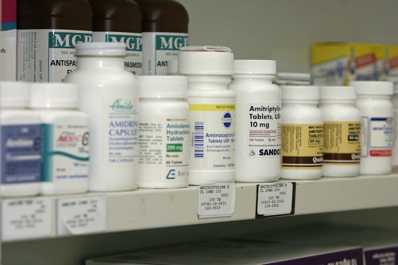 Pharmacy counter with prescription medication bottles being prepared
