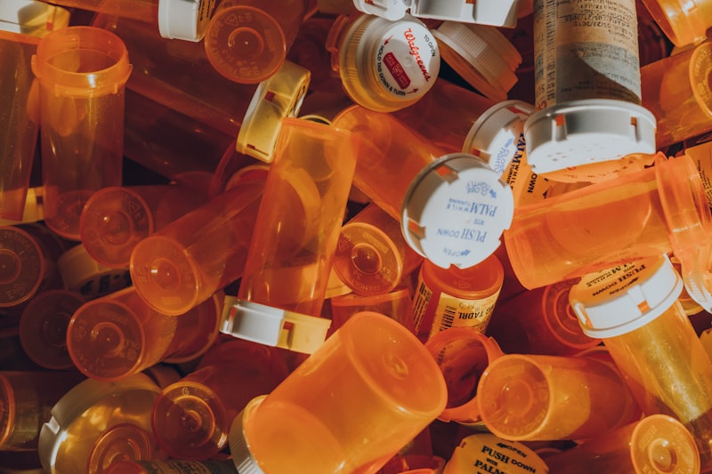 Calculator and prescription bottles on a desk representing pharmacy cost comparisons