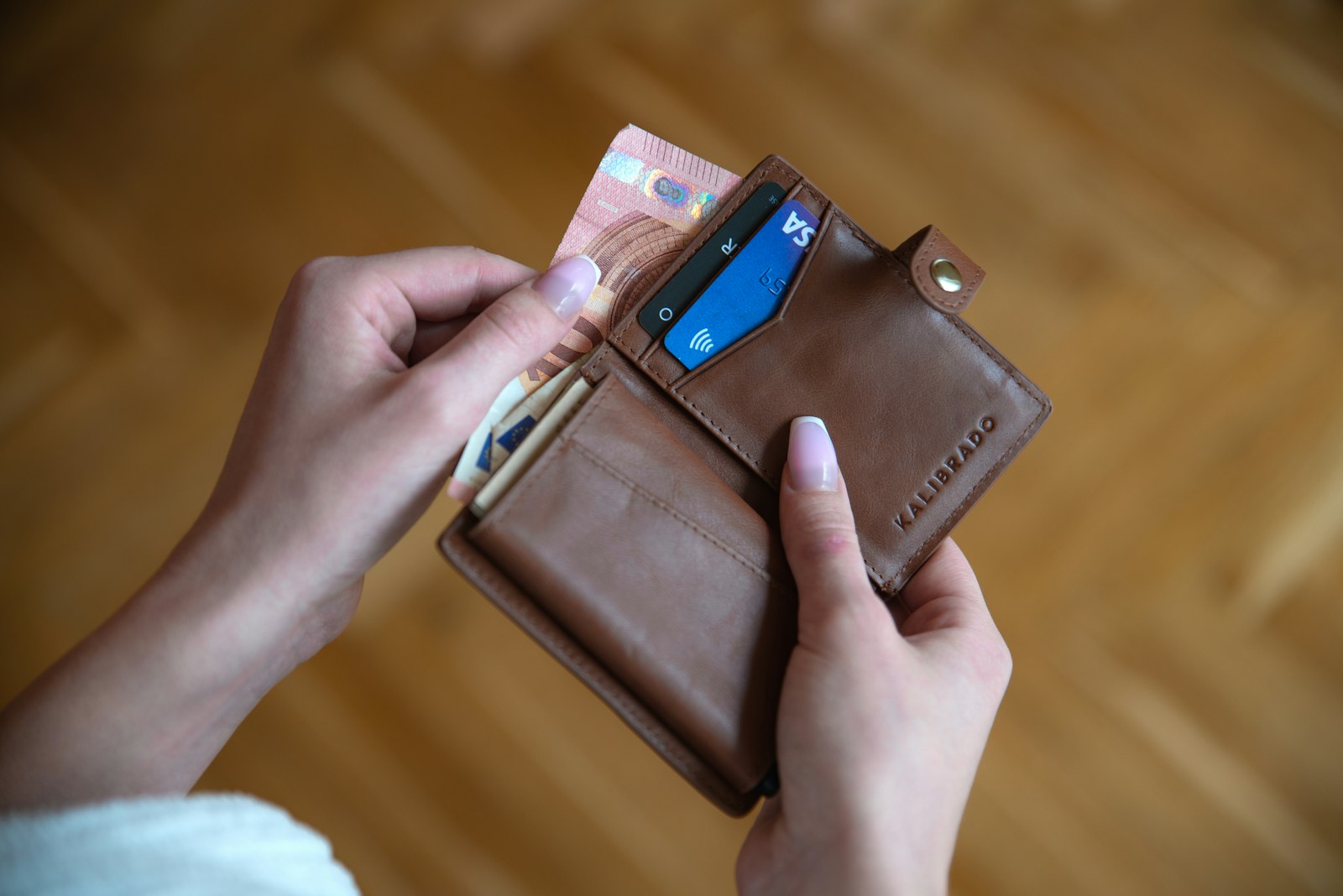 Person holding a wallet with prescription discount cards
