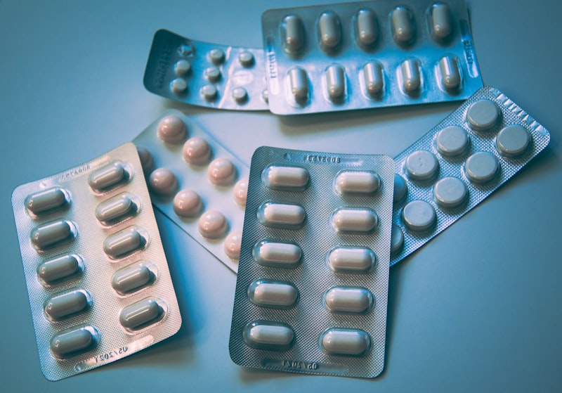 Prescription drug pills and discount cards used to compare pharmacy prices