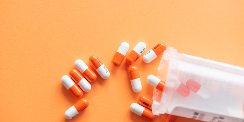 Generic prescription medication bottles and pills arranged on a counter