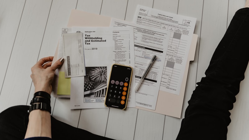 Calculator and financial documents on desk representing prescription cost calculations