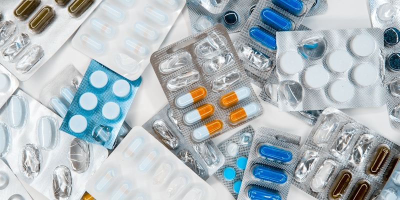 Row of prescription medication bottles on a pharmacy shelf
