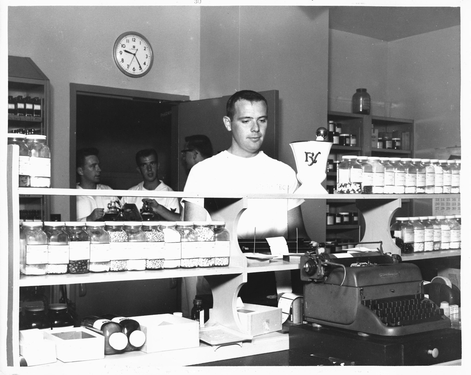 Pharmacists working behind a retail pharmacy counter